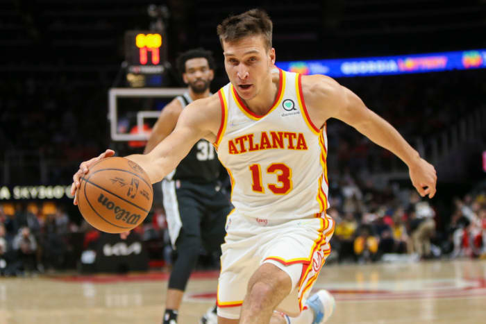 Feb 11, 2022; Atlanta, Georgia, USA; Atlanta Hawks guard Bogdan Bogdanovic (13) grabs a loose ball against the San Antonio Spurs in the second quarter at State Farm Arena.